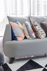 colorful pillows on modern grey sofa