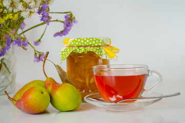 Tea, Jar of Apple Jam and Pears on White Table. With flowers on back.