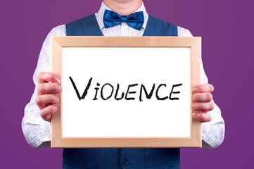 a man with a sign in his hand with the word violence