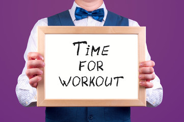 a man with a sign in his hand with the inscription time for workout