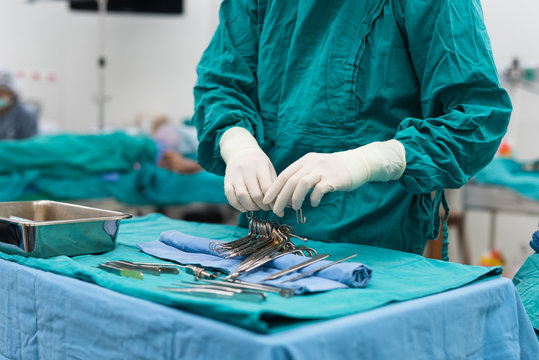 scrub nurse prepare medical equipments for surgery