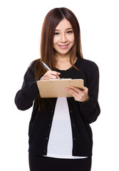 Fototapeta premium Young woman take note on clipboard