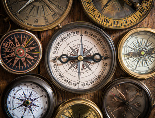 Old compass on vintage wood
