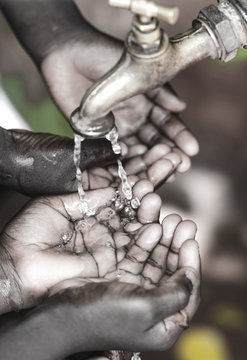 African Baby Cupped Hands Begging for Clean, Fresh Water