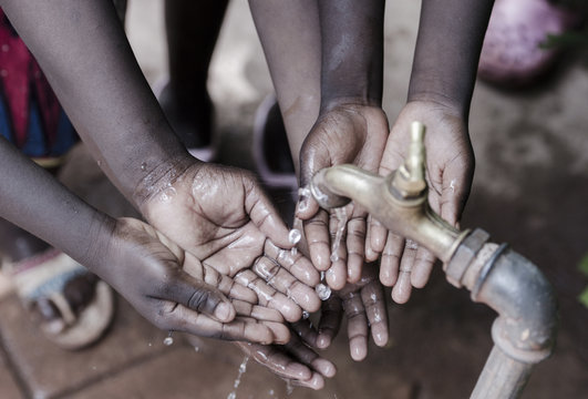 Clean Water Splashing Into African Child's Hands Life Metaphore