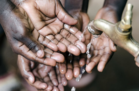 Lots Of Hands Under Water Tap In Africa