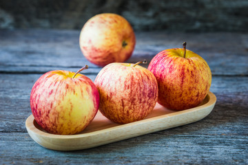 Apples on old wooden background.