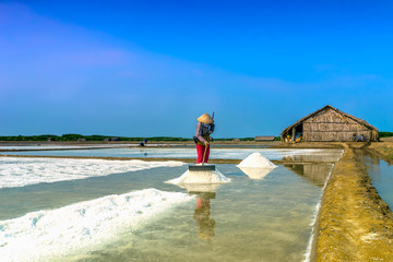 The woman harvesting salt, Vietnam