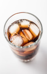 Cola glass with ice cubes on a white background