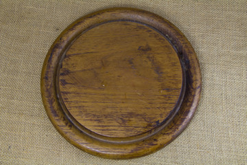 Circle wooden block on sack background