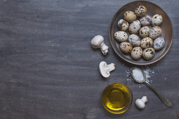 Plate with quail eggs, salt, olive oil and mushrooms