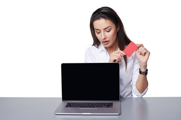 Business woman with laptop showing credit card