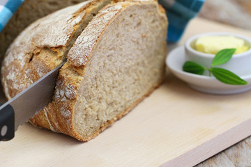 Rustic rye bread on wooden board, closeup
