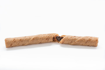 Broken chocolate waffle stick roll. White background.