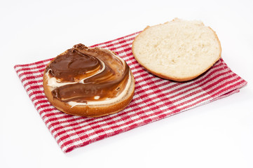 Bread with chocolate cream on the kitchen table cloth
