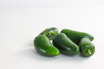 hot green peppers on a white background 