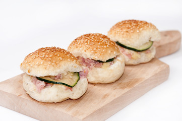 Hamburger sandwiches with ham and cucumber
