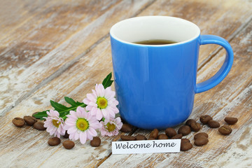 Welcome home card with mug of coffee and pink daisies
