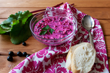 Fritters with a raspberry on wooden plate