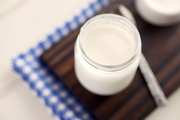 Simple Homemade Yogurt. High angle view of glass jar with yogurt in it. Very shallow depth of field.