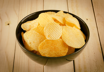 potato chips on wood - soft focus with vintage film filter
