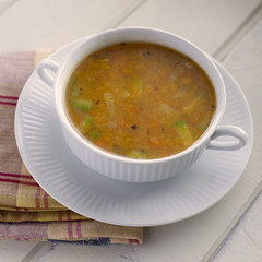 Veggie soup. High angle view of vegetables soup inside porcelain bowl