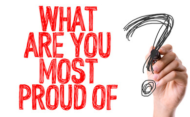 Hand with marker writing: What Are You Most Proud Of?
