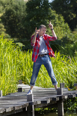 happy young man dancing on wooden bridge for fun satisfaction