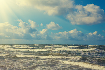 Fototapeta premium Marine landscape with stormy sea and blue cloudy sky