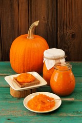 Homemade sweet pumpkin jam on rye toast, in white plate and in g