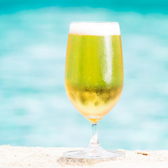 Glass of beer on blue background