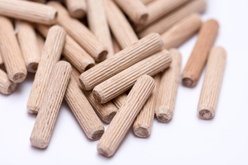 Pile of wooden dowels on the white background