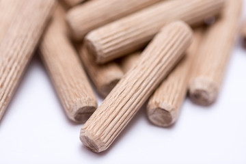 Pile of wooden dowels on the white background