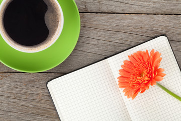 Blank notepad, coffee cup and orange gerbera flower