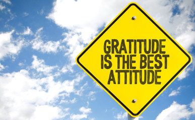 Gratitude Is The Best Attitude sign with sky background