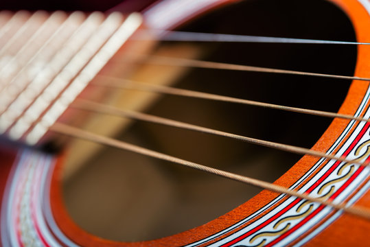 Details of  guitar with 5 strings.  shallow depth of field