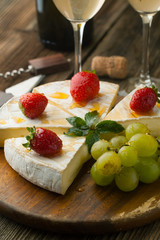 Cheese with strawberries and honey