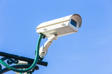 The security camera against blue sky
