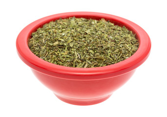 Portion of Italian seasoning in a red dish on white