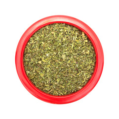 Italian seasoning in a red dish on white background