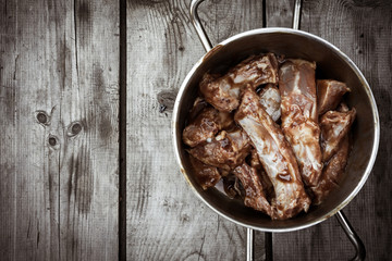 BBQ Pork Ribs in pan on wooden background with copy space