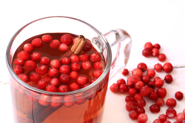 tea with cranberry and cinnamon on a white wooden background Christmas