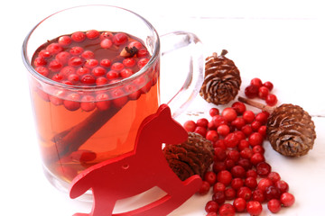 Christmas tea with cranberry Christmas decorations cones grog cider winter white wooden background...