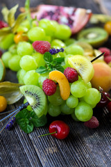 Delicious mixed fresh fruits on wooden background