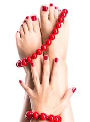 Poster Closeup photo of a female feet with beautiful red pedicure © Valua Vitaly