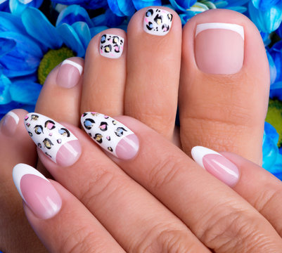 woman's nails of hands and legs with french manicure