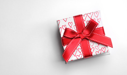White gift box with bow and painted hearts isolated top