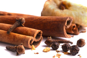 Spices and dried fruit isolated on white.