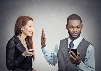 woman being ignored stopped by young handsome man looking at smartphone