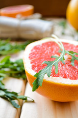 Grapefruit with fresh arugula leaves